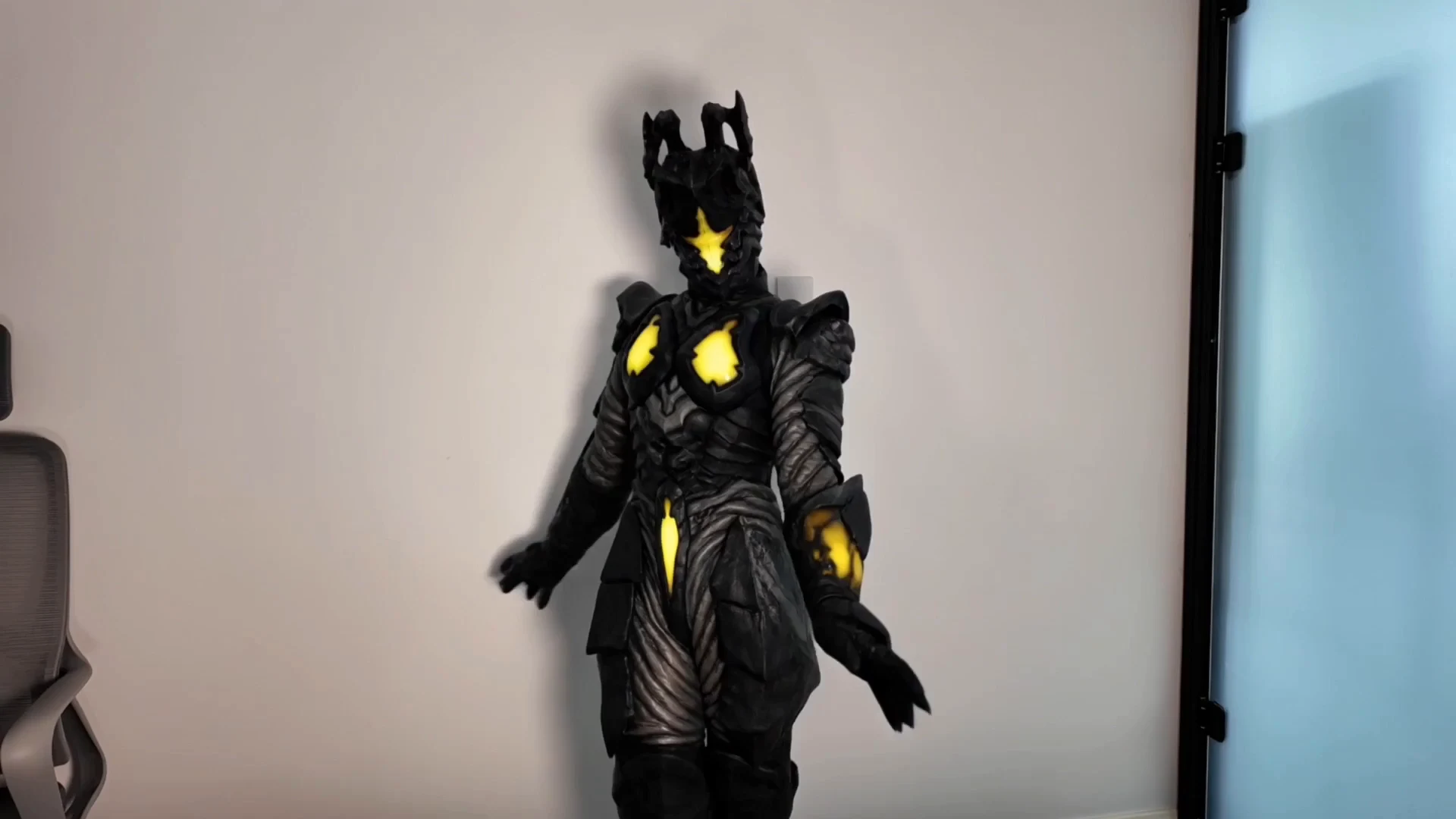 Competitor face-swap demonstration frame showing a character in black armor indoors